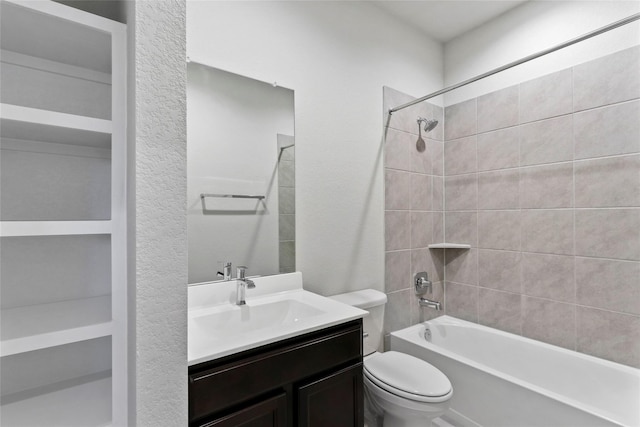 bathroom with toilet, vanity, and washtub / shower combination