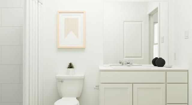 bathroom with toilet and vanity