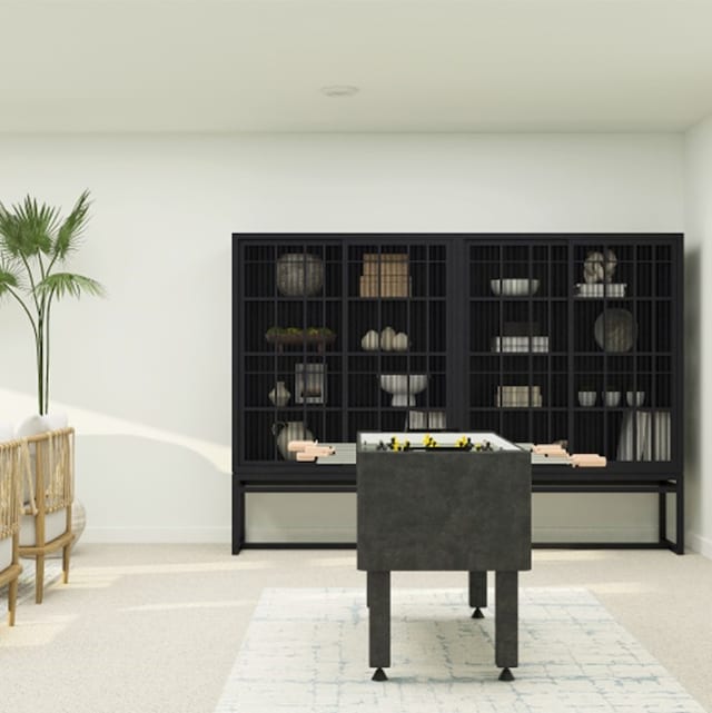 living area with baseboards and carpet flooring