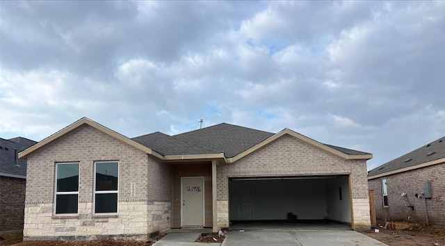 9318 Vendace Dr, Baytown, TX 77521 - view of front facade with brick siding, concrete driveway, an attached garage, a shingled roof, and stone siding