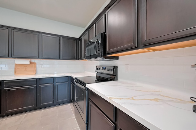 kitchen featuring black microwave, stainless steel electric range oven, light stone counters, and tasteful backsplash