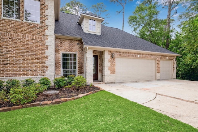 view of front of home with a front lawn, a shingled roof, brick siding, concrete driveway, and an attached garage