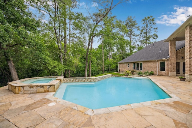 view of swimming pool with a pool with connected hot tub, french doors, and a patio area