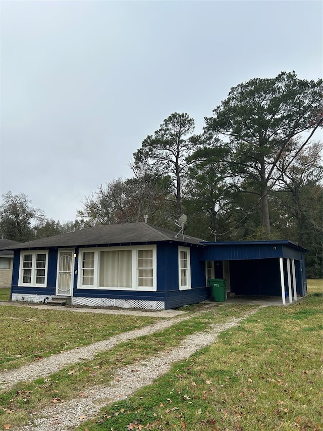304 Tanner Ave, Cleveland, TX 77327 - view of front facade with a front yard, a carport, and driveway