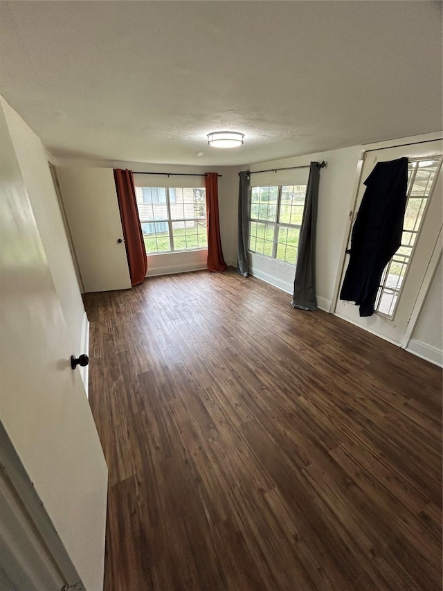 304 Tanner Ave, Cleveland, TX 77327 - unfurnished room with dark wood-type flooring and baseboards