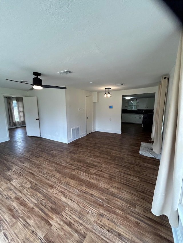 304 Tanner Ave, Cleveland, TX 77327 - unfurnished living room with wood finished floors, baseboards, and ceiling fan