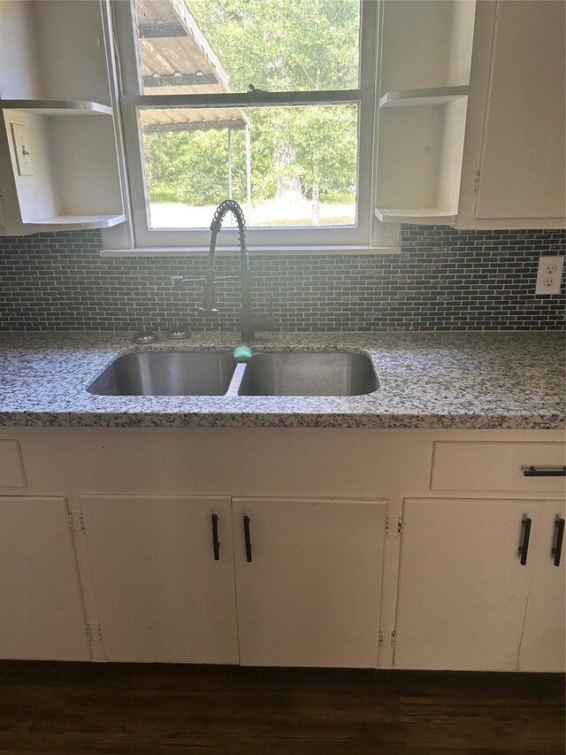 304 Tanner Ave, Cleveland, TX 77327 - kitchen with open shelves, a sink, tasteful backsplash, and white cabinetry