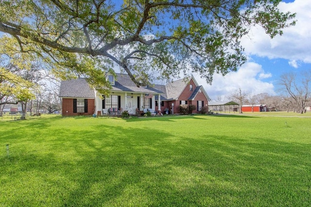 315 County Road 893, Angleton, TX 77515 - rear view of house with a lawn, a porch, and brick siding