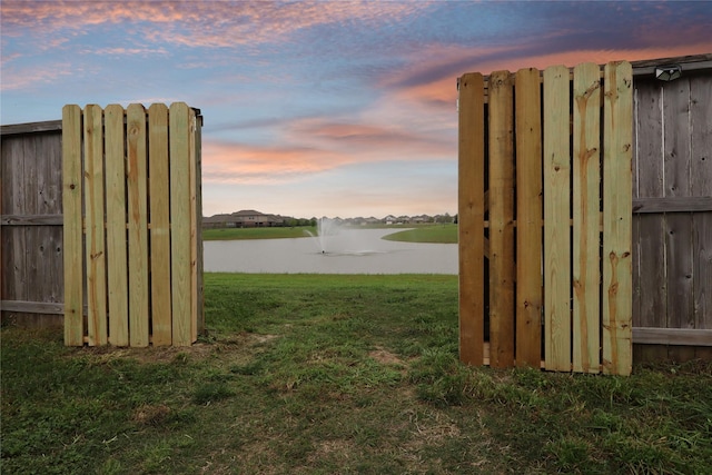 2225 Windy Sail Dr, Texas City, TX 77568 - yard at dusk with a water view