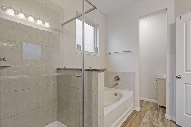 2225 Windy Sail Dr, Texas City, TX 77568 - full bathroom featuring a bath, a shower stall, and wood finished floors