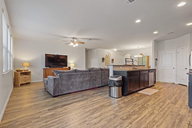 2225 Windy Sail Dr, Texas City, TX 77568 - living area with ceiling fan with notable chandelier, visible vents, recessed lighting, light wood finished floors, and baseboards