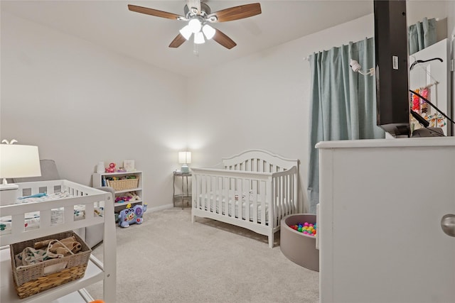 2225 Windy Sail Dr, Texas City, TX 77568 - bedroom featuring ceiling fan, baseboards, carpet, and a nursery area