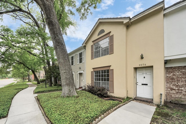 9654 Westview Dr Unit 9, Houston, TX 77055 - view of front facade with stucco siding and brick siding