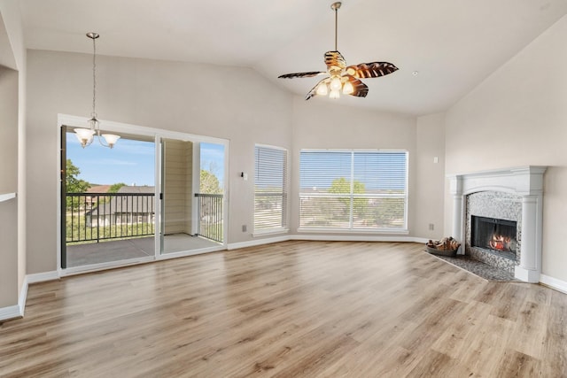12800 Melville Dr Unit B307, Montgomery, TX 77356 - unfurnished living room featuring high vaulted ceiling, a chandelier, light wood-type flooring, a fireplace, and ceiling fan