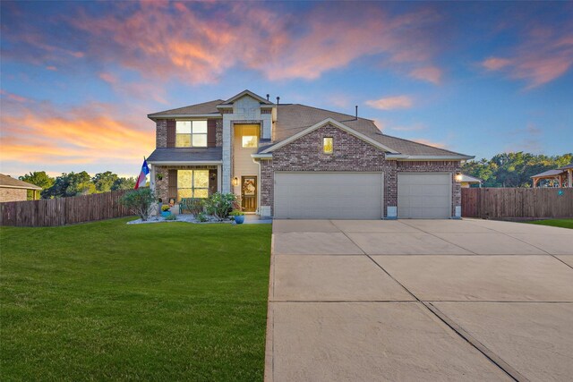 13295 Hidden Trail Ct, Willis, TX 77318 - traditional-style home featuring a garage, driveway, and brick siding