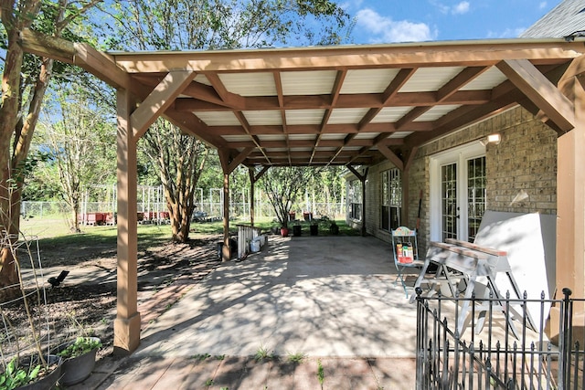 view of patio / terrace featuring a carport and fence