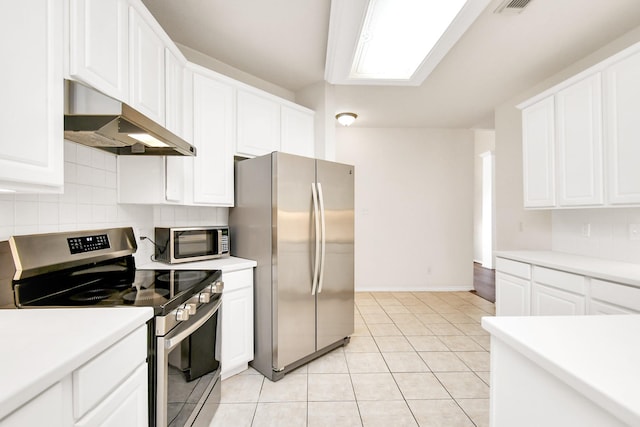 kitchen with light countertops, tasteful backsplash, appliances with stainless steel finishes, and under cabinet range hood