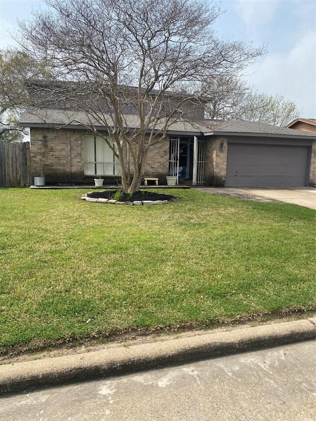 view of front of house featuring brick siding, a front yard, driveway, and fence