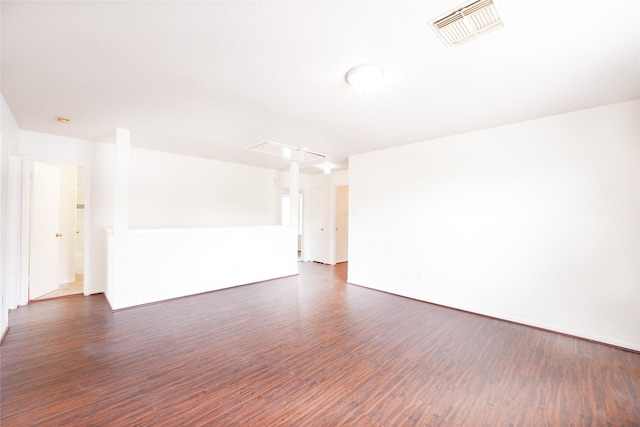 unfurnished room with dark wood finished floors and visible vents