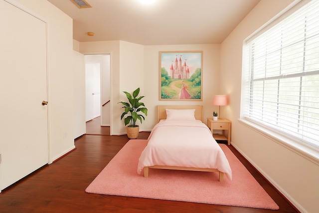 bedroom featuring baseboards, visible vents, and dark wood-type flooring