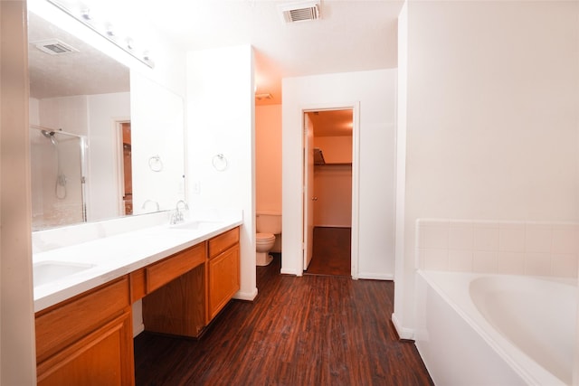 bathroom featuring a sink, a shower stall, visible vents, and wood finished floors