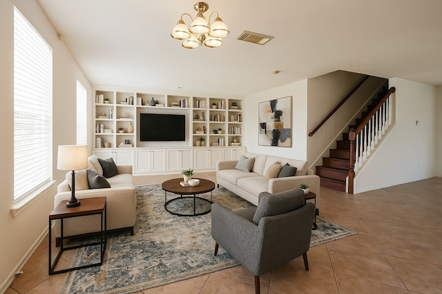 tiled living area with baseboards, stairway, an inviting chandelier, and visible vents