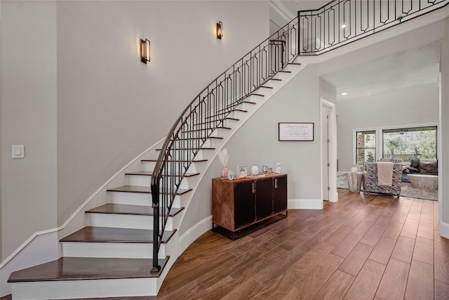 27415 Siandra Creek Ln, Spring, TX 77386 - stairs with wood finished floors, baseboards, and a high ceiling
