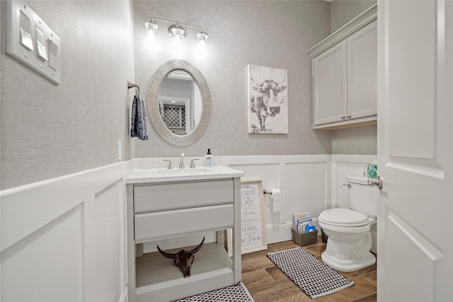 27415 Siandra Creek Ln, Spring, TX 77386 - half bathroom with a decorative wall, toilet, vanity, and a wainscoted wall