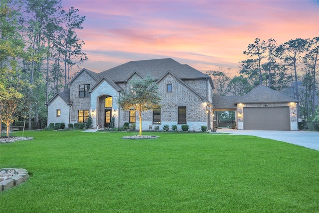 27415 Siandra Creek Ln, Spring, TX 77386 - french country inspired facade featuring stone siding, concrete driveway, an attached garage, a front yard, and roof with shingles