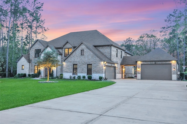 27415 Siandra Creek Ln, Spring, TX 77386 - french provincial home with driveway, a garage, a front yard, and brick siding