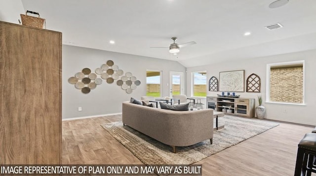 living room with baseboards, visible vents, wood finished floors, and ceiling fan