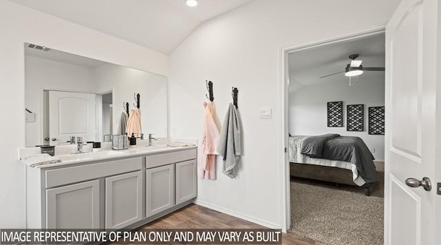 full bath featuring double vanity, vaulted ceiling, a sink, visible vents, and a ceiling fan