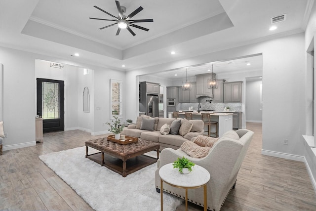 13130 Victoria Trce, Montgomery, TX 77316 - living room featuring light wood-style flooring, a tray ceiling, visible vents, recessed lighting, and ceiling fan