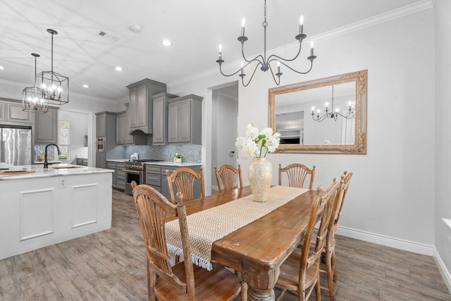 13130 Victoria Trce, Montgomery, TX 77316 - dining room featuring crown molding, wood finished floors, a chandelier, visible vents, and recessed lighting