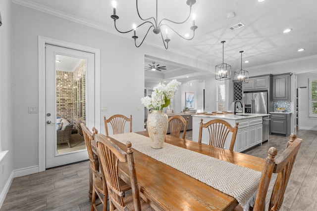 13130 Victoria Trce, Montgomery, TX 77316 - dining area featuring recessed lighting, wood finished floors, visible vents, crown molding, and baseboards