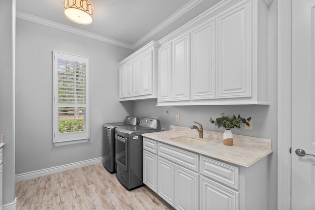 13130 Victoria Trce, Montgomery, TX 77316 - laundry room featuring light wood-style flooring, a sink, cabinet space, independent washer and dryer, and crown molding