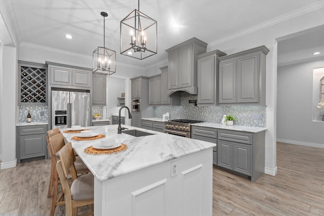 13130 Victoria Trce, Montgomery, TX 77316 - kitchen featuring gray cabinets, a notable chandelier, premium appliances, and a sink