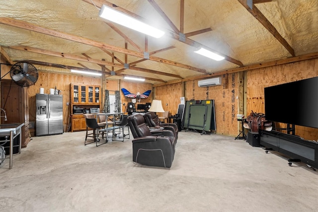 13130 Victoria Trce, Montgomery, TX 77316 - living room with a garage, an AC wall unit, and unfinished concrete flooring