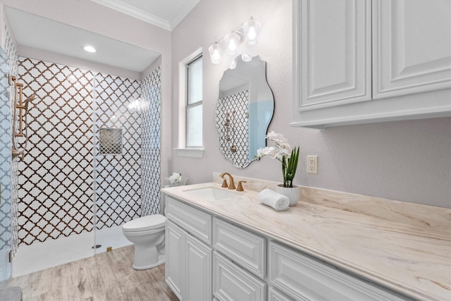 13130 Victoria Trce, Montgomery, TX 77316 - full bath with crown molding, wood finished floors, vanity, a tile shower, and toilet