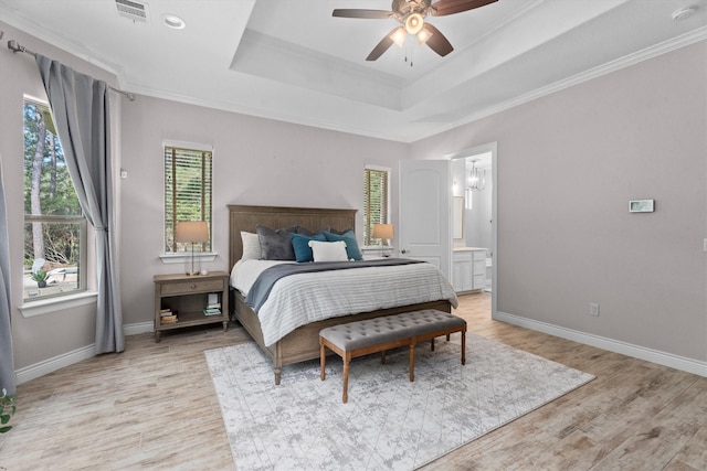 13130 Victoria Trce, Montgomery, TX 77316 - bedroom with crown molding, a tray ceiling, light wood finished floors, baseboards, and visible vents