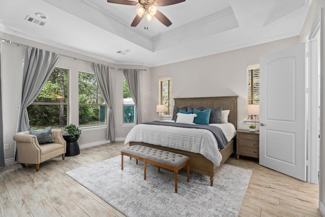 13130 Victoria Trce, Montgomery, TX 77316 - bedroom featuring a raised ceiling, visible vents, light wood-style floors, crown molding, and baseboards