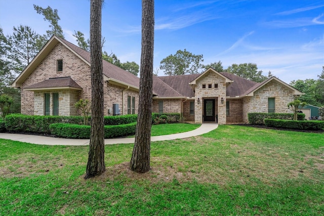 13130 Victoria Trce, Montgomery, TX 77316 - view of front facade featuring a front lawn, brick siding, and roof with shingles