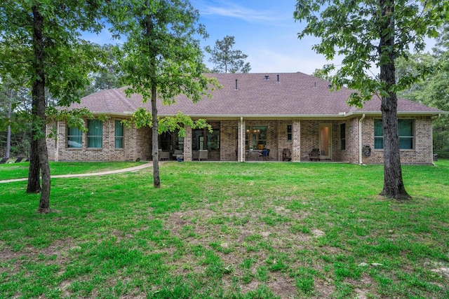 13130 Victoria Trce, Montgomery, TX 77316 - single story home with a shingled roof, a front lawn, and brick siding