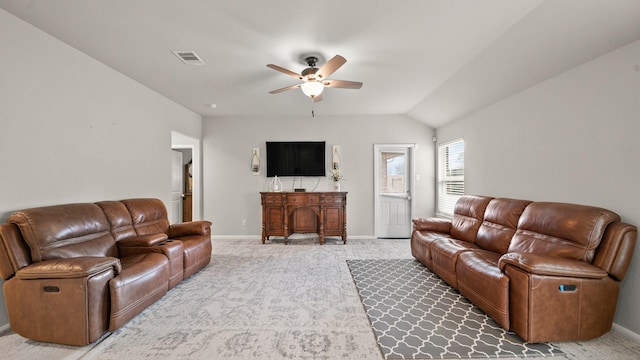 carpeted living area with baseboards, a ceiling fan, visible vents, and lofted ceiling