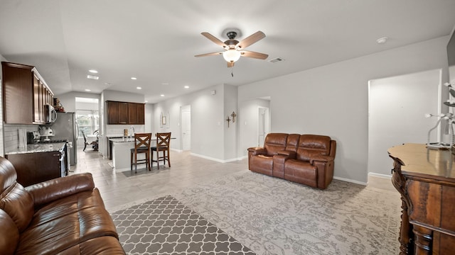living room with a ceiling fan, visible vents, recessed lighting, light tile patterned flooring, and baseboards