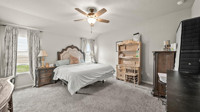 carpeted bedroom with baseboards, a ceiling fan, and lofted ceiling