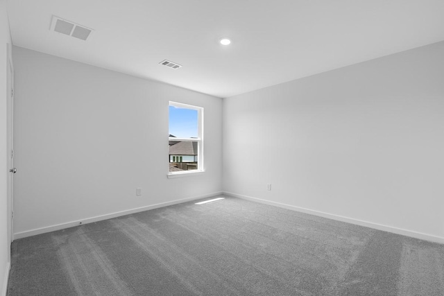 unfurnished room featuring baseboards, visible vents, recessed lighting, and carpet flooring