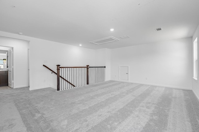 spare room with light carpet, baseboards, visible vents, and recessed lighting