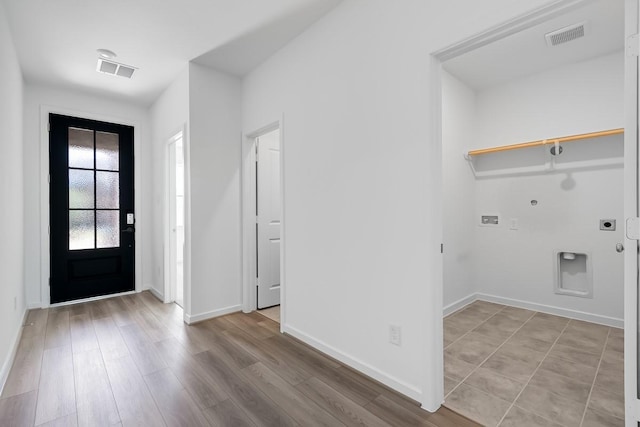 interior space featuring light wood-style floors, visible vents, and baseboards