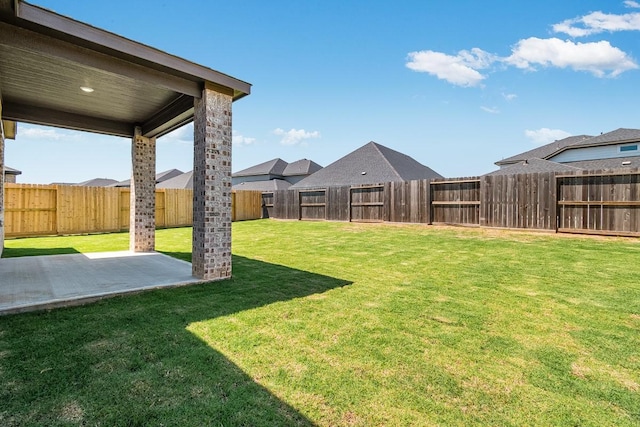 view of yard with a fenced backyard and a patio
